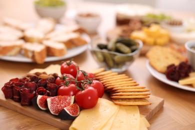 Photo of Assorted appetizers served on wooden table, selective focus. Space for text
