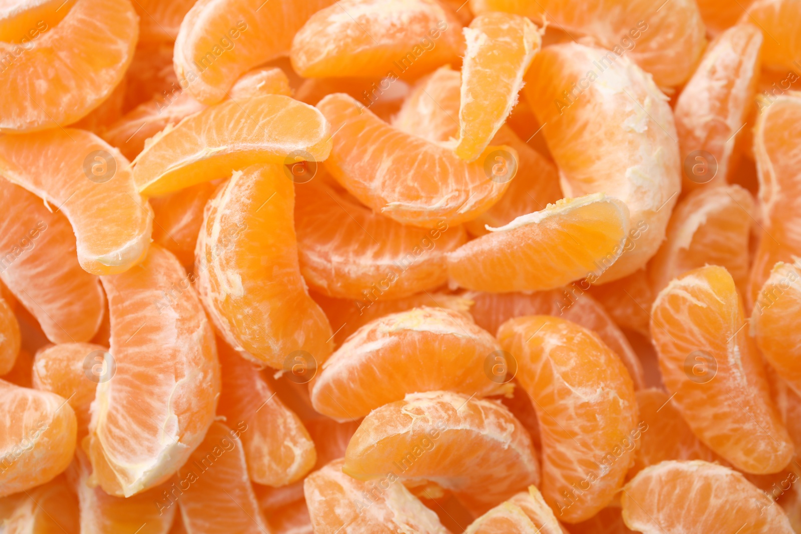 Photo of Segments of tasty tangerines as background, top view