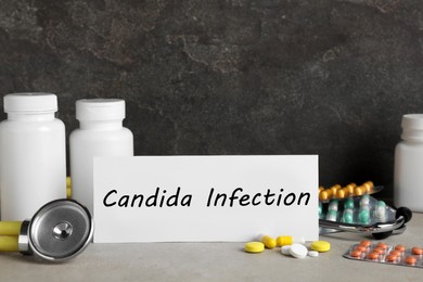 Image of Card with phrase Candida Infection, drugs and stethoscope on light grey table