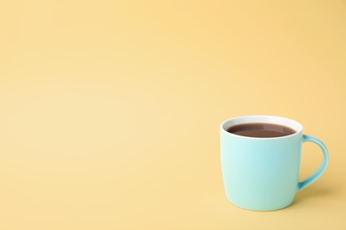 Photo of Blue ceramic cup with hot aromatic coffee on color background