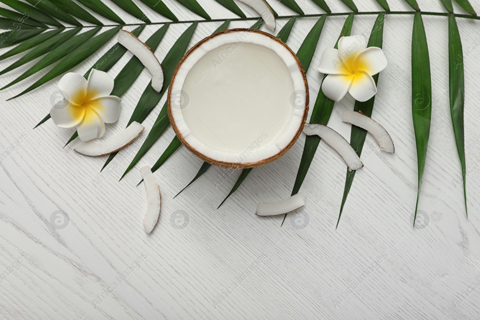 Photo of Flat lay composition with half of coconut on white wooden background