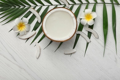 Photo of Flat lay composition with half of coconut on white wooden background