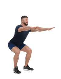 Photo of Man doing squats on white background. Morning exercise