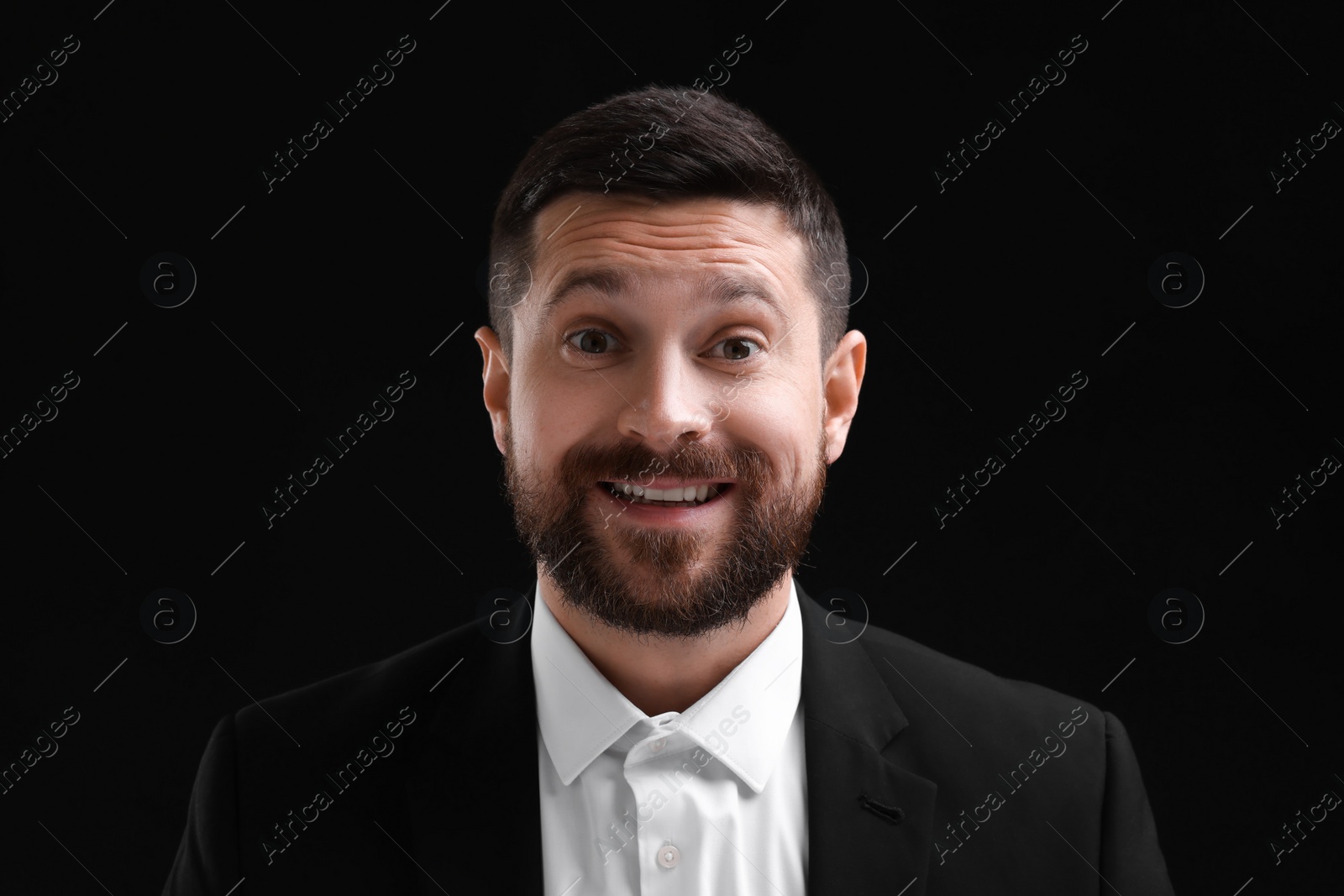 Photo of Personality concept. Happy man on black background