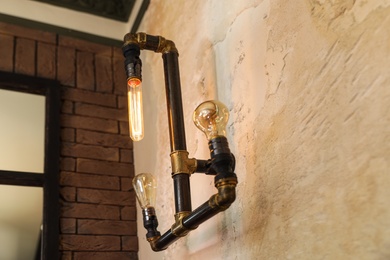 Photo of Retro lamp in steam punk style on the wall indoors