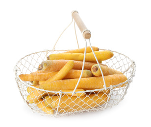 Photo of Raw yellow carrots in metal basket isolated on white