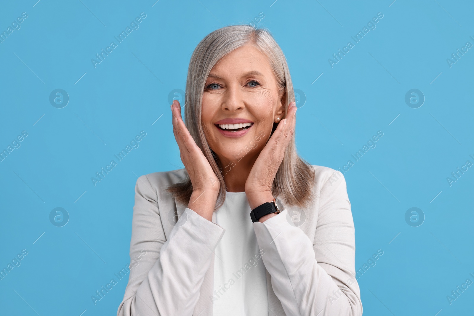 Photo of Portrait of emotional middle aged woman on light blue background