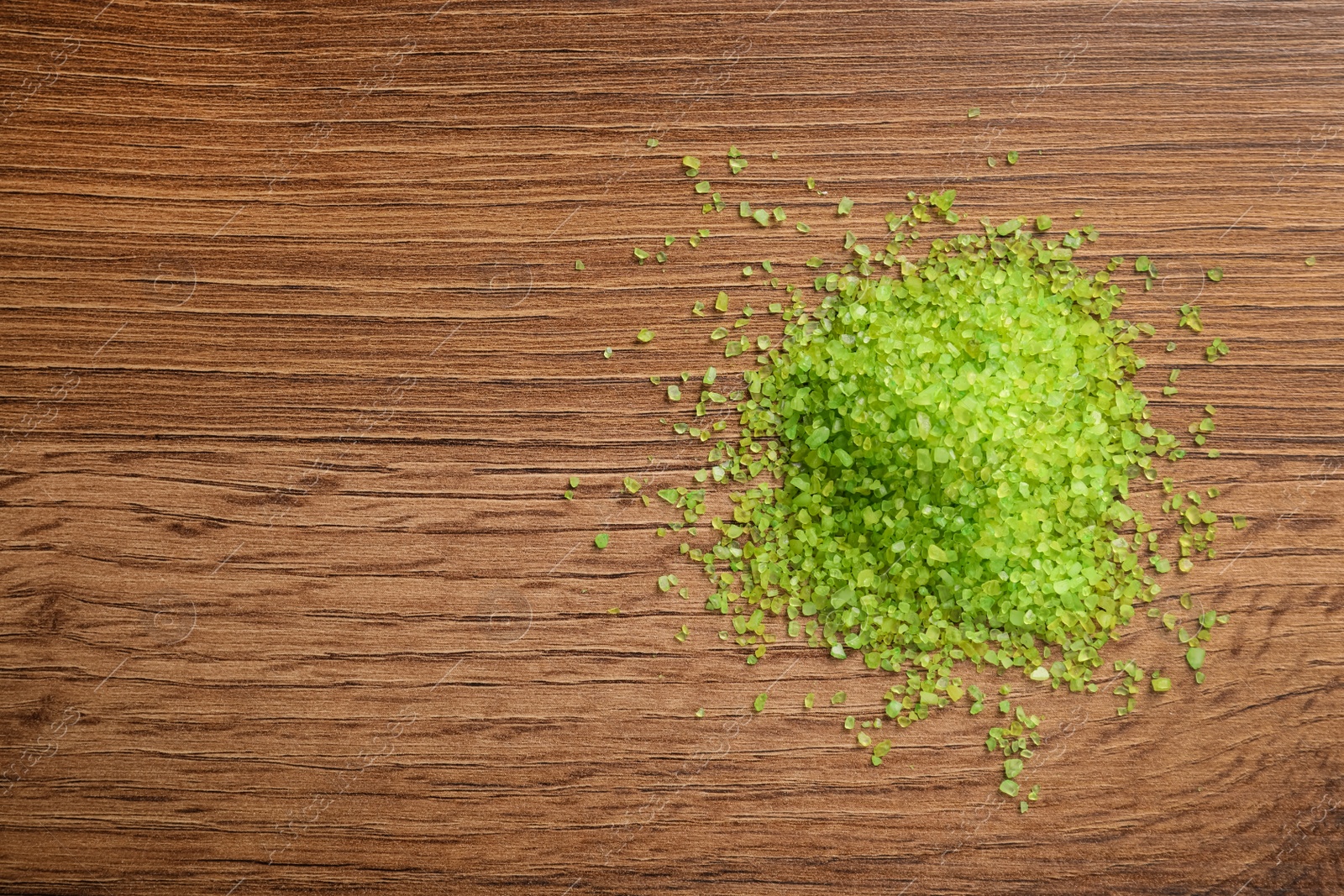 Photo of Aromatic sea salt on wooden table, top view. Space for text