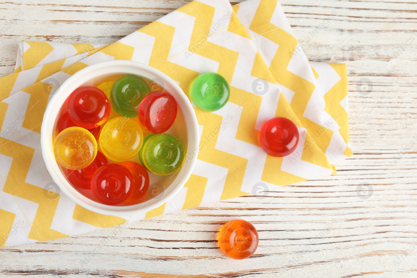 Photo of Flat lay composition with delicious colorful candies on wooden background