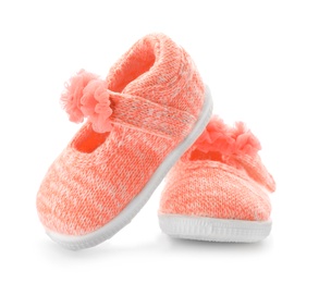 Photo of Pair of pink baby shoes on white background