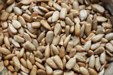 Photo of Pile of peeled sunflower seeds as background, closeup