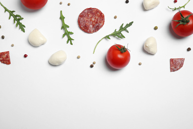 Photo of Composition with fresh ingredients for pepperoni pizza on white background, top view