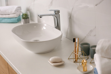 Stylish vessel sink on light countertop in modern bathroom