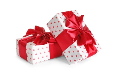 Photo of Beautifully wrapped gift boxes on white background