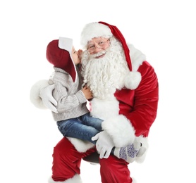 Photo of Little boy whispering in authentic Santa Claus' ear against white background
