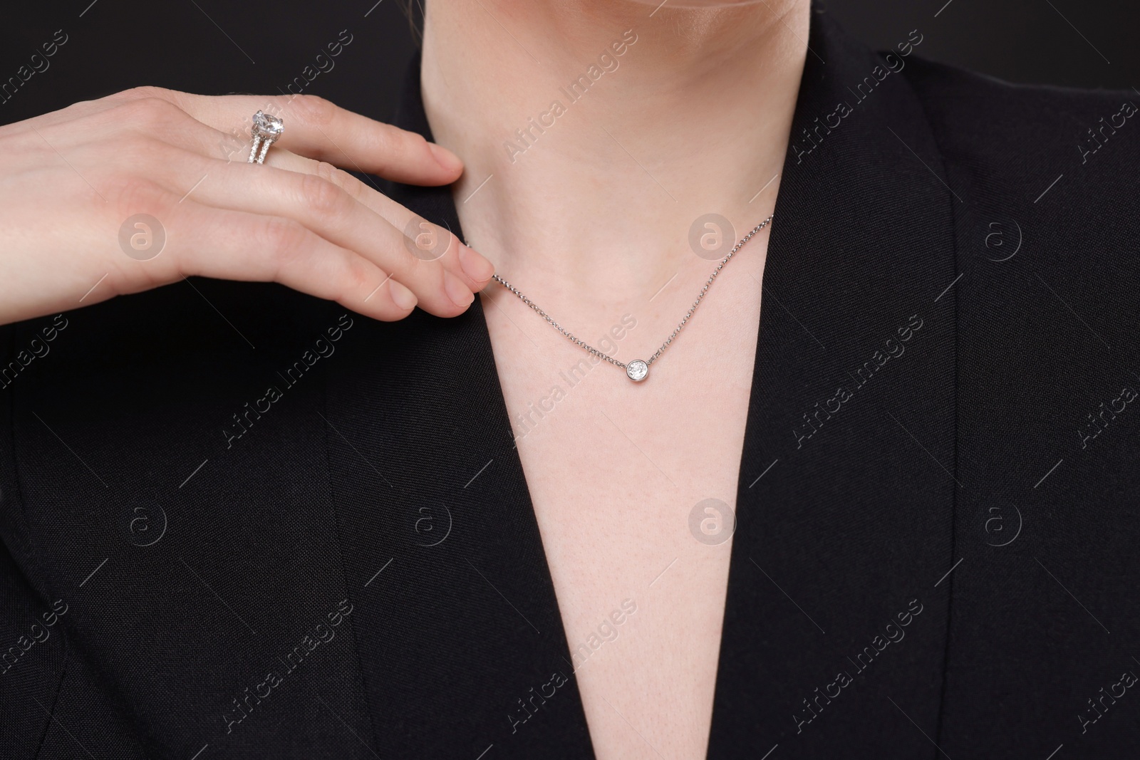 Photo of Woman with elegant jewelry on black background, closeup