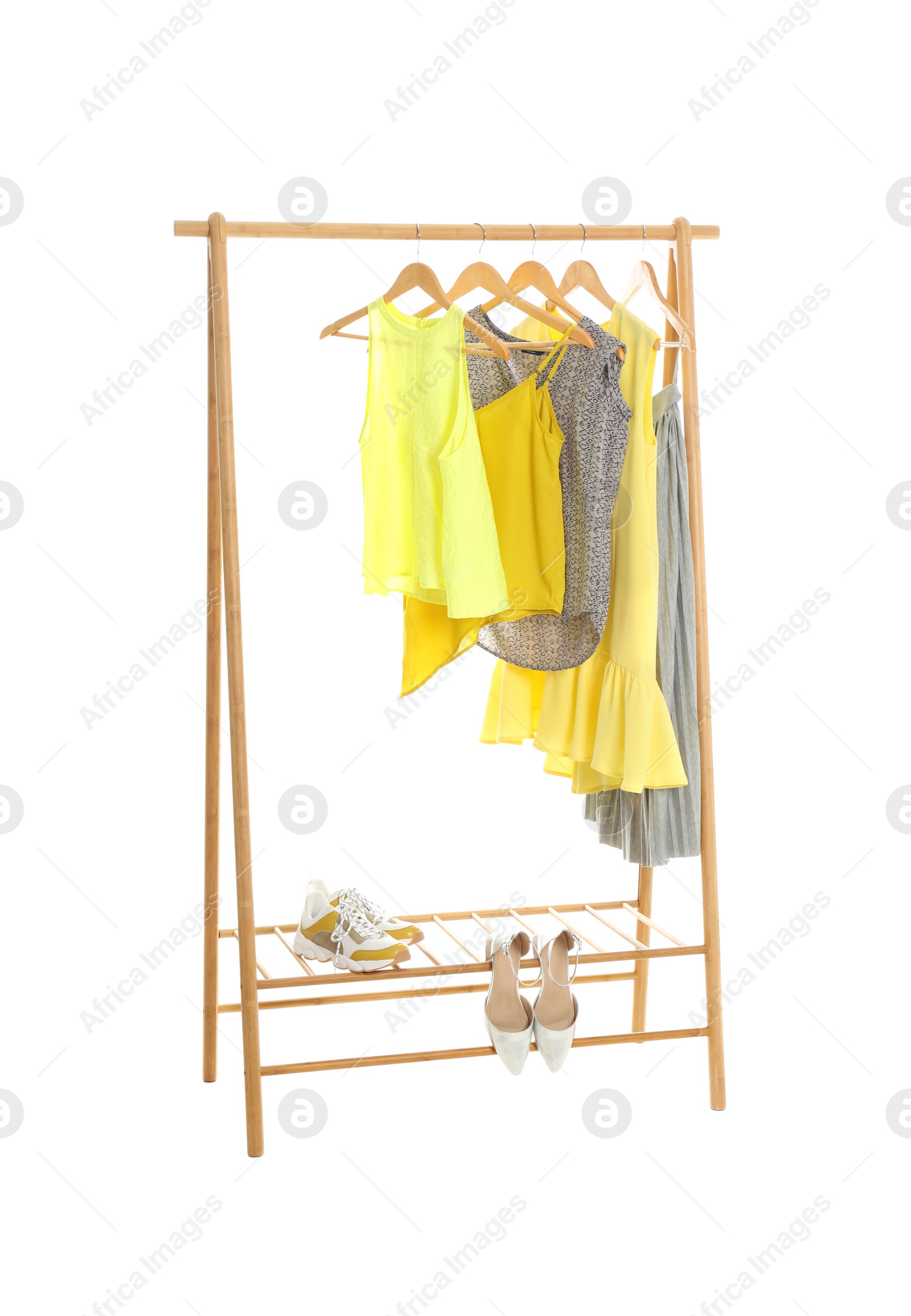 Photo of New wardrobe rack with stylish lady's clothes and shoes on white background