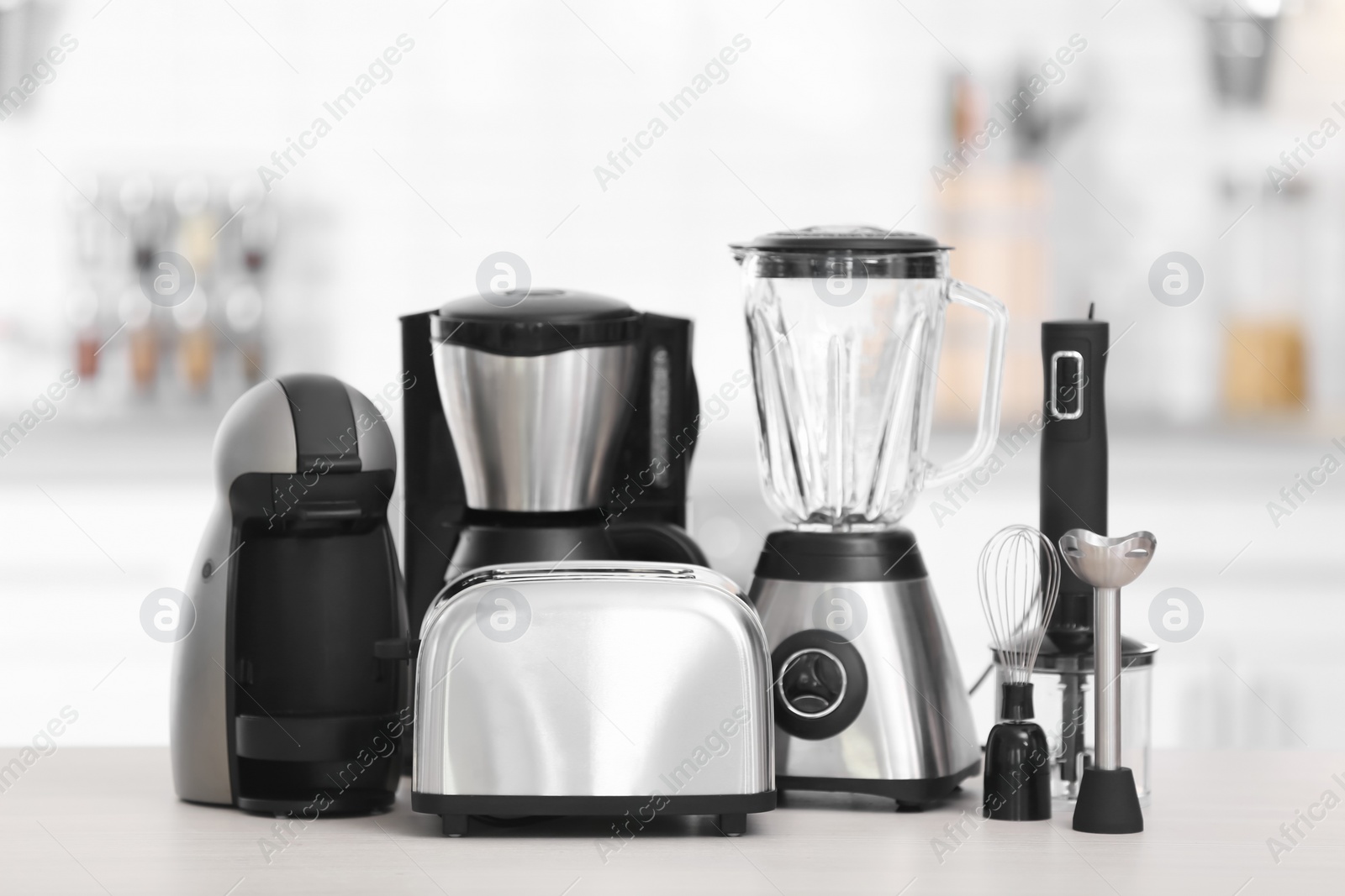 Photo of Different modern kitchen appliances on table indoors. Interior element