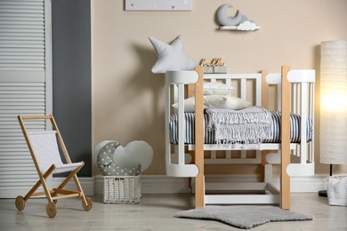 Photo of Cute baby room interior with modern crib and toys