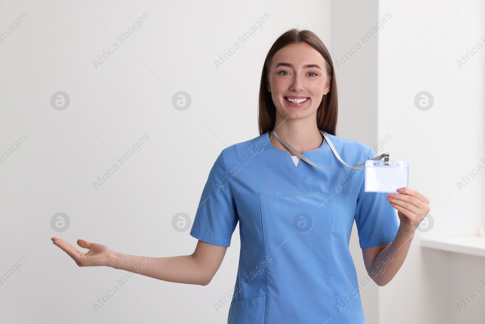 Photo of Happy doctor with blank badge in hospital