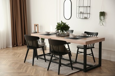 Photo of Stylish wooden dining table and chairs in room. Interior design