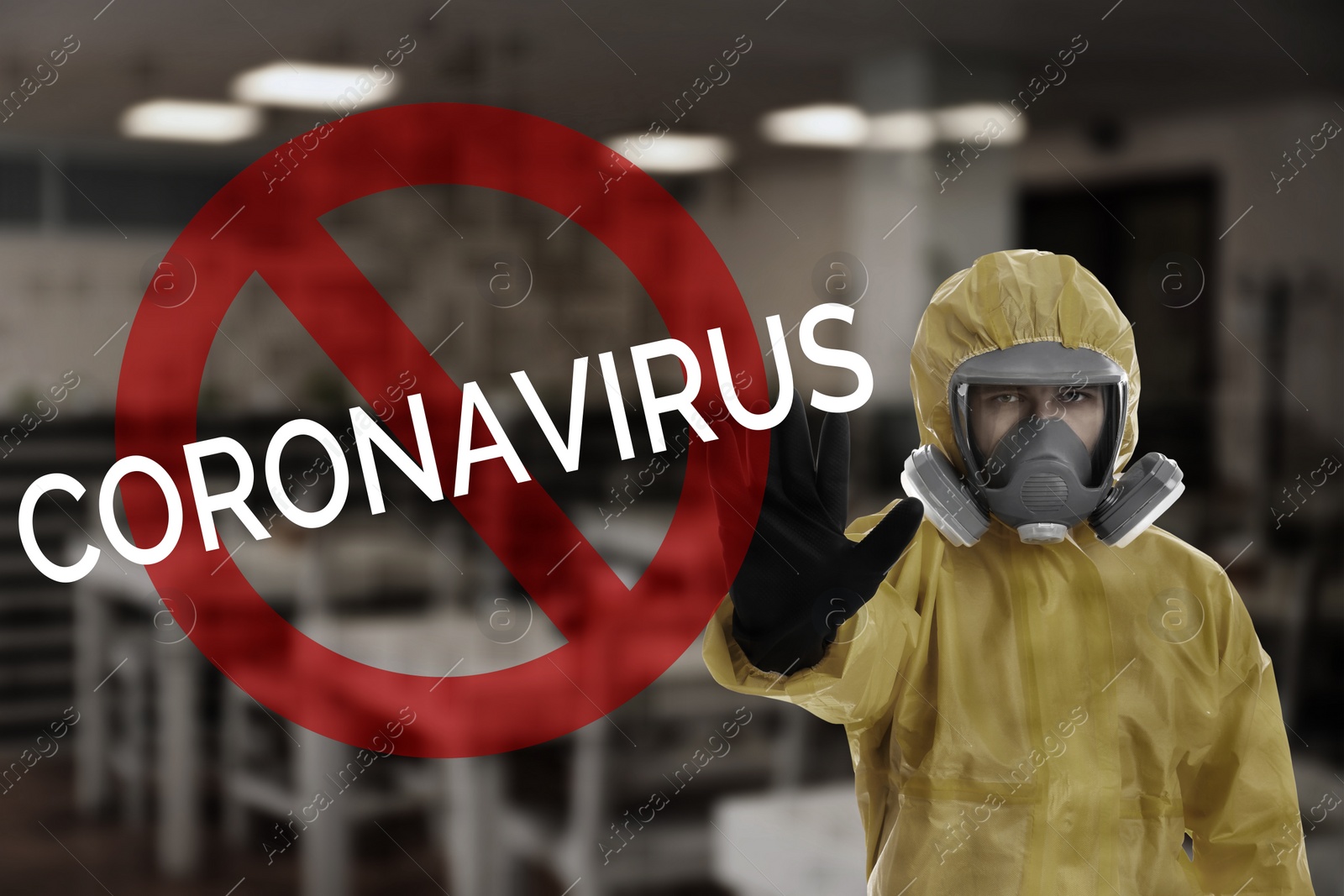 Image of Man in chemical protective suit showing STOP gesture indoors. Prevention of virus spread