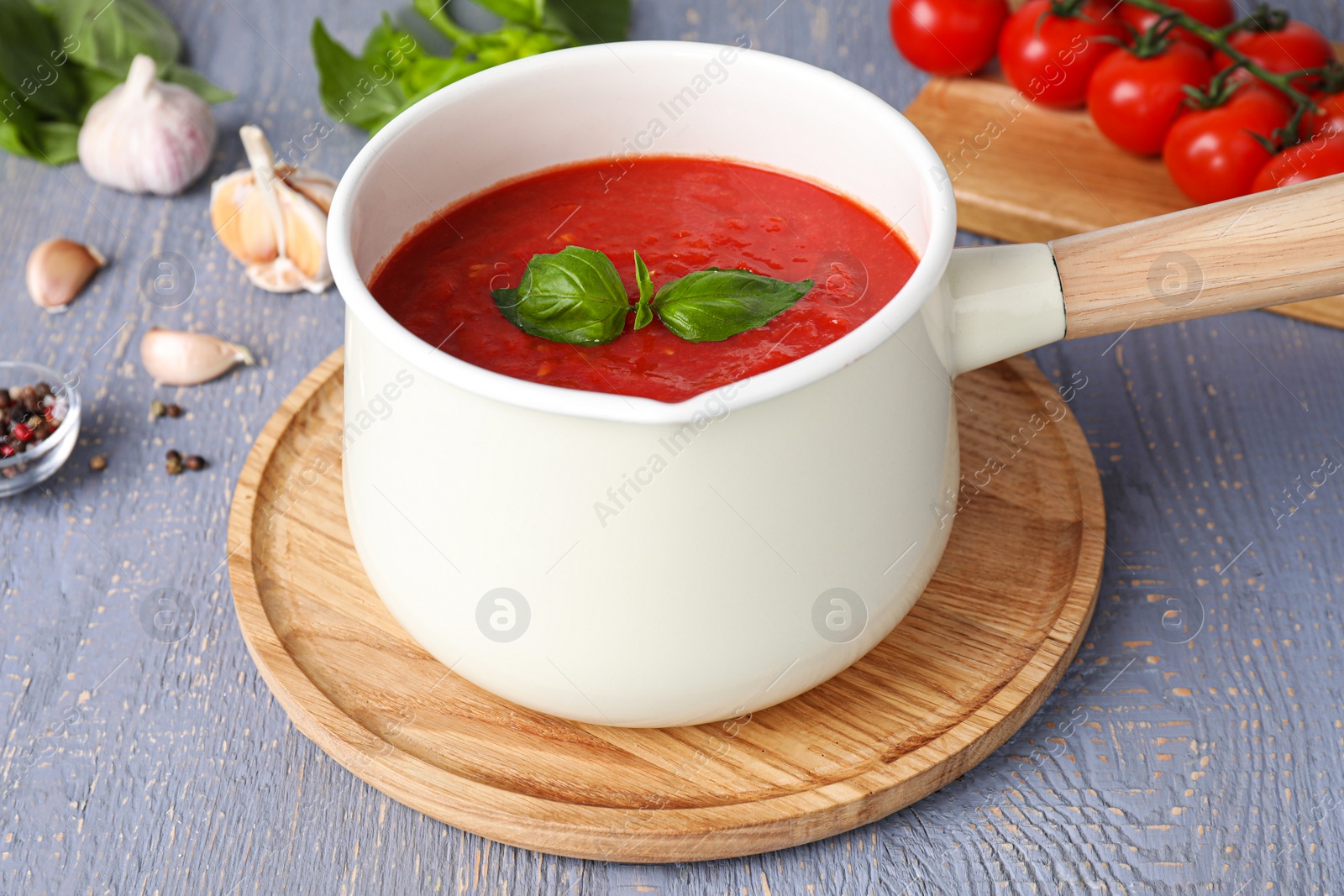 Photo of Delicious tomato sauce on grey wooden table