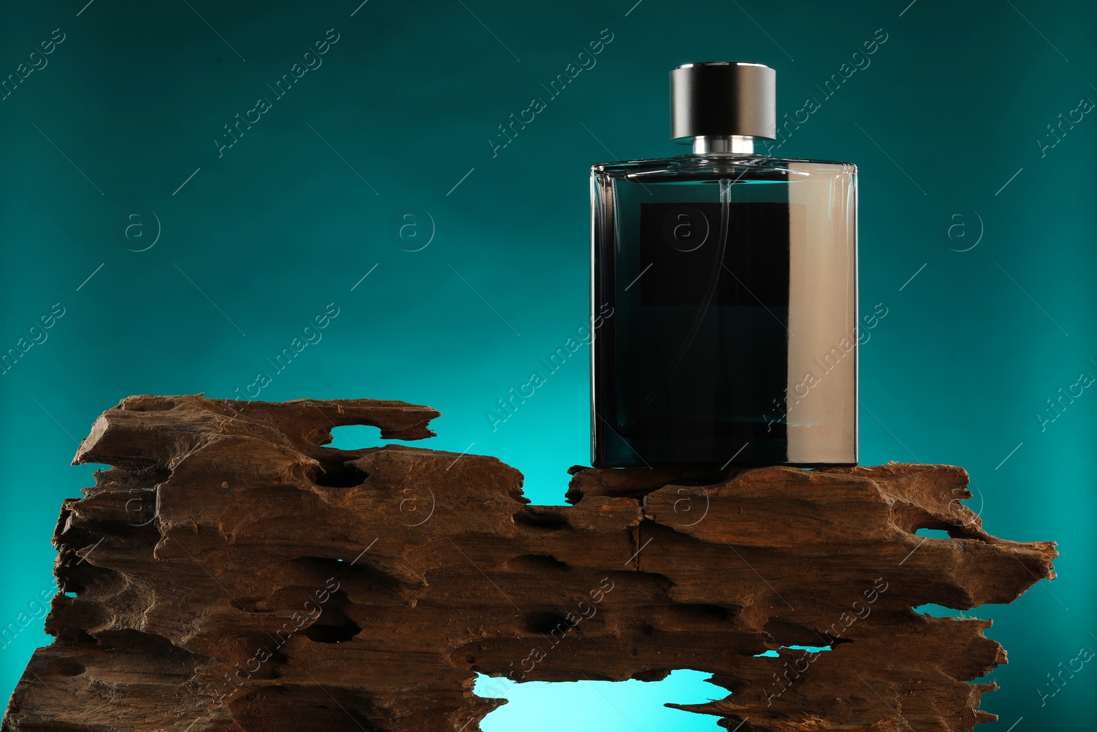 Photo of Luxury men`s perfume in bottle against color background, space for text