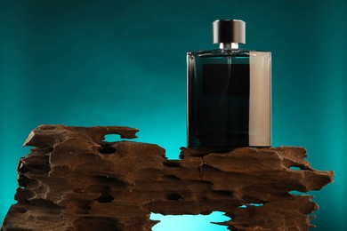 Photo of Luxury men`s perfume in bottle against color background, space for text