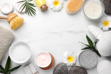 Flat lay composition with different spa products on white marble table. Space for text