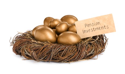 Photo of Many golden eggs and card with phrase Pension Investments in nest on white background