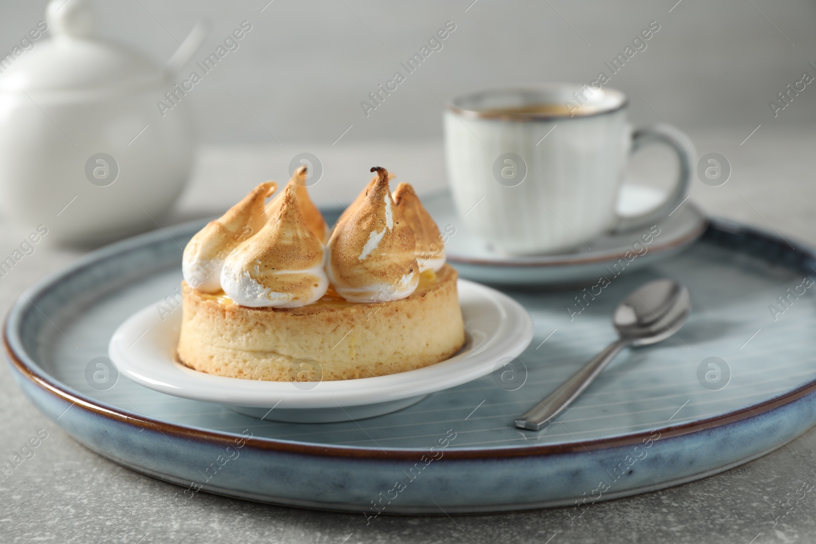 Photo of Delicious lemon meringue pie on grey table, closeup