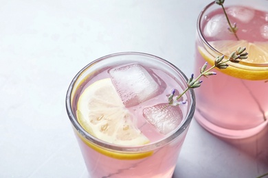 Photo of Natural lemonade with lavender in glasses on light background