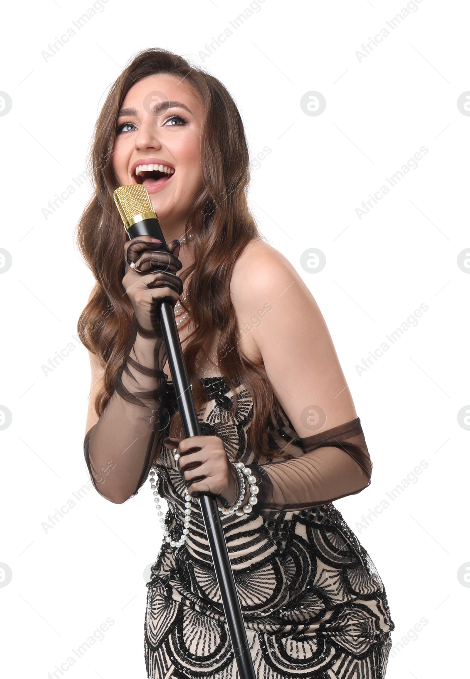 Photo of Beautiful young woman in stylish dress with microphone singing on white background