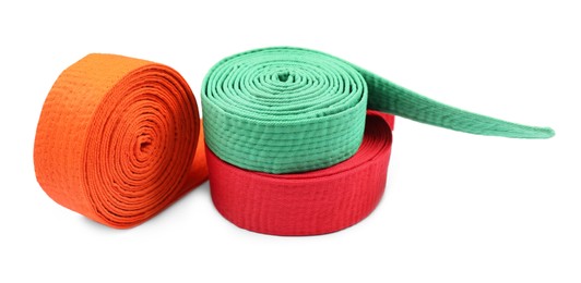 Orange, green and red karate belts isolated on white