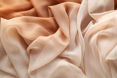 Photo of Beautiful beige tulle fabric as background, top view