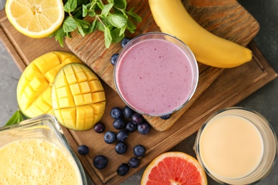 Flat lay composition with healthy detox smoothies and ingredients on table