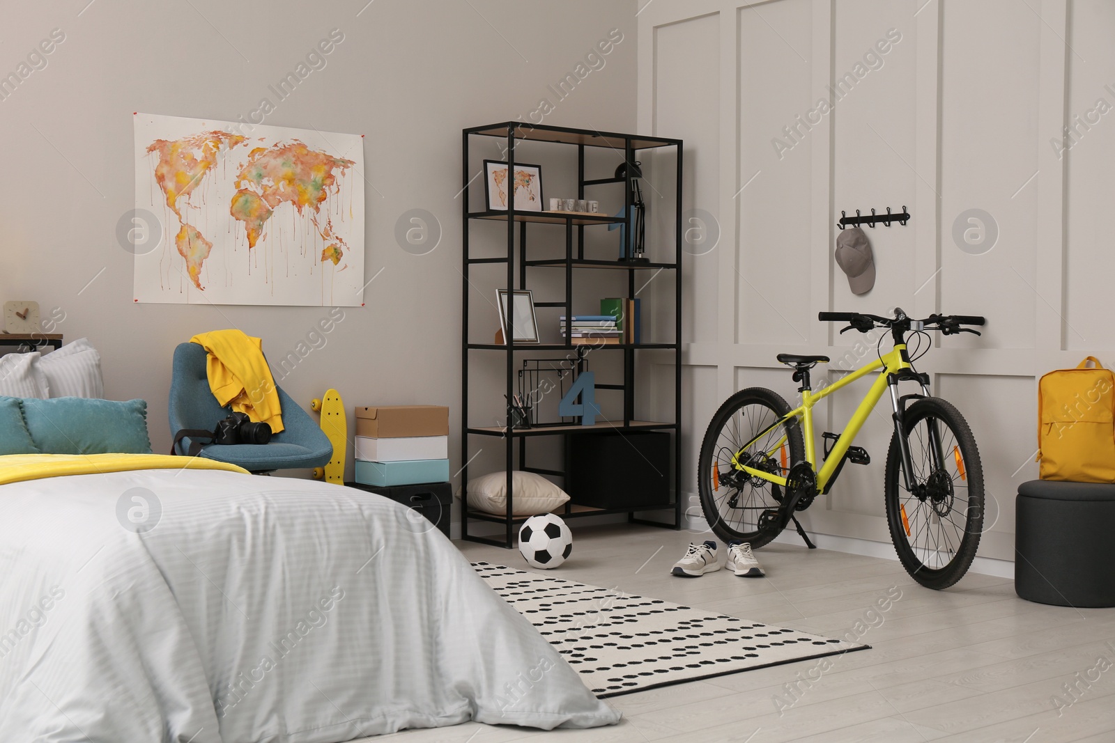 Photo of Stylish teenager's room interior with comfortable bed and sports equipment