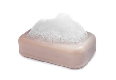Photo of Soap bar with fluffy foam on white background