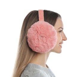 Happy woman wearing warm earmuffs on white background