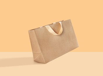 Image of Kraft paper bag on color background. Mockup for design