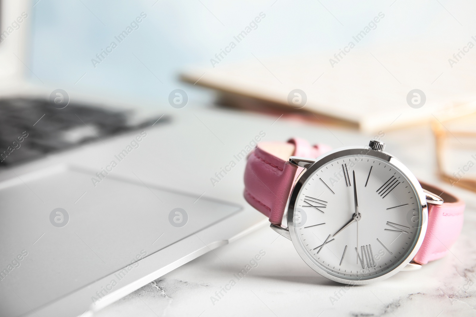 Photo of Stylish wrist watch on office table, space for text. Fashion accessory