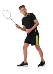 Young man playing badminton with racket on white background