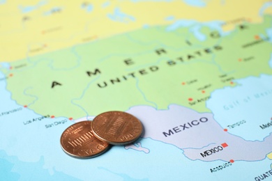 Photo of Two national coins near USA on world map