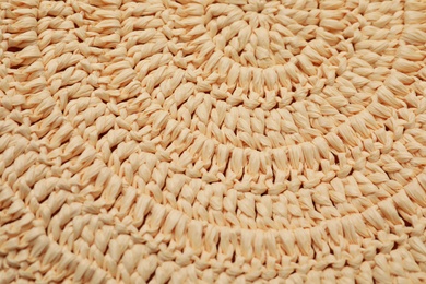 Elegant woman's straw bag as background, closeup