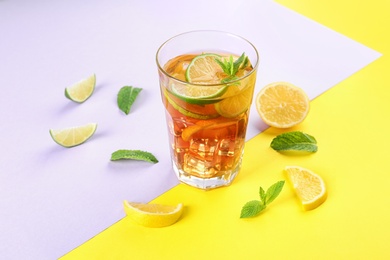 Photo of Glass of refreshing iced tea on color table