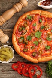 Photo of Delicious pizza Diablo and ingredients on wooden table, flat lay