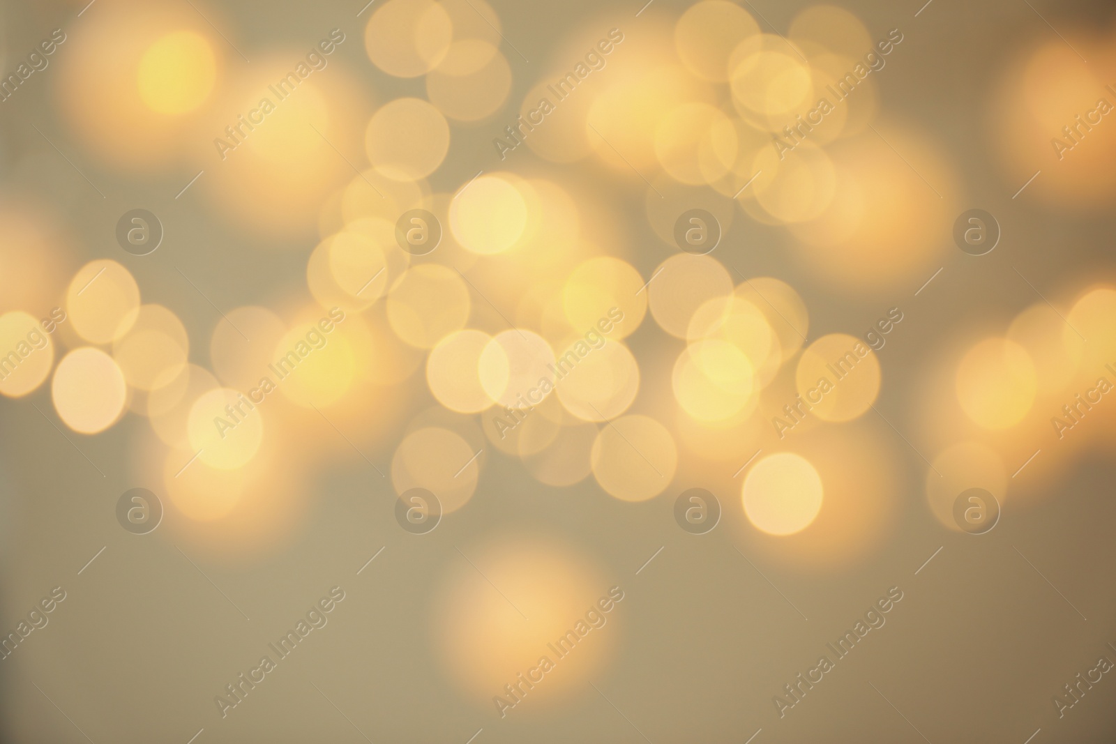 Photo of Blurred view of shiny gold lights. Bokeh effect