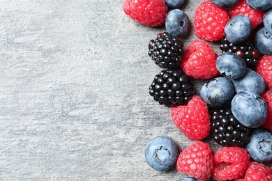 Raspberries, blackberries and blueberries on table, top view