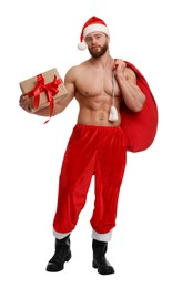 Attractive young man with muscular body in Santa hat holding bag and Christmas gift box on white background